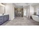 Elegant bathroom features a spacious walk-in shower, soaking tub, and double vanity at 125 Drummond Pl, Covington, GA 30014