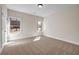 Bright bedroom featuring two windows, neutral carpet, and white trim at 125 Drummond Pl, Covington, GA 30014