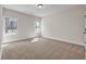 Spacious bedroom with carpet, white trim, and ample natural light from windows at 125 Drummond Pl, Covington, GA 30014