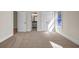 Bedroom featuring neutral carpet, access to bathroom, and natural light from a single window at 125 Drummond Pl, Covington, GA 30014