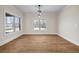 Inviting dining room with natural light, hardwood flooring, and a contemporary light fixture at 125 Drummond Pl, Covington, GA 30014