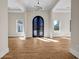 Elegant entryway with a decorative wrought iron front door and gleaming wood floors at 125 Drummond Pl, Covington, GA 30014