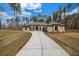Lovely single story home featuring a sprawling front lawn and long driveway at 125 Drummond Pl, Covington, GA 30014