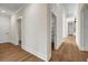 View of hallway with hardwood floors and white trim, leading to various rooms at 125 Drummond Pl, Covington, GA 30014