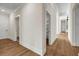 Hallway features hardwood flooring and bright white trim, adding style and elegance at 125 Drummond Pl, Covington, GA 30014
