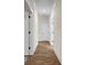Hallway features hardwood flooring, white trim, and an access panel to the attic at 125 Drummond Pl, Covington, GA 30014
