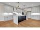 Stylish kitchen with white cabinetry, stainless steel appliances, and hardwood flooring at 125 Drummond Pl, Covington, GA 30014