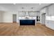 Bright, modern kitchen features white cabinets, stone countertops, an island and stainless appliances at 125 Drummond Pl, Covington, GA 30014