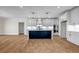 Modern kitchen featuring white cabinets, stainless steel appliances, and a contrasting navy island at 125 Drummond Pl, Covington, GA 30014