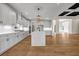 Spacious open-concept kitchen with stone counters, stainless appliances, island and hardwood floors at 125 Drummond Pl, Covington, GA 30014