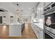 Well-equipped kitchen with a central island, white cabinets, and stainless steel appliances at 125 Drummond Pl, Covington, GA 30014