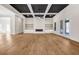 Expansive living area featuring coffered ceiling, hardwood floors and custom fireplace with built-in shelving at 125 Drummond Pl, Covington, GA 30014