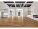 Open-concept living room with hardwood floors, a fireplace, and a decorative ceiling at 125 Drummond Pl, Covington, GA 30014