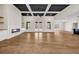 Spacious living area featuring a coffered ceiling, hardwood floors, and a modern fireplace with built-ins at 125 Drummond Pl, Covington, GA 30014