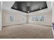Bright living room featuring a modern fireplace, dark tray ceiling, and lots of natural light at 125 Drummond Pl, Covington, GA 30014