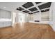 Open-concept living room with recessed lighting, coffered ceilings, and sleek hardwood floors at 125 Drummond Pl, Covington, GA 30014