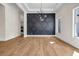 Bright living area featuring hardwood floors and a dark gray accent wall with geometric patterns at 125 Drummond Pl, Covington, GA 30014