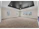 Spacious living room featuring many windows, tray ceiling and neutral decor at 125 Drummond Pl, Covington, GA 30014