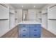 Large walk-in closet featuring plenty of shelves and an island with drawers for storage at 125 Drummond Pl, Covington, GA 30014