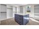 Large walk-in closet featuring plenty of shelves and an island with drawers for storage at 125 Drummond Pl, Covington, GA 30014