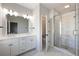 Modern bathroom featuring a double vanity, marble floors, a glass shower, and stylish lighting at 434 Herring Dr, Acworth, GA 30102