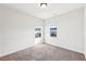 Bright and airy bedroom with two windows providing natural light, complemented by neutral carpet and walls at 434 Herring Dr, Acworth, GA 30102
