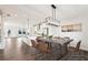Bright dining area with modern chandelier, wood floors, and an open floor plan connecting to the kitchen at 434 Herring Dr, Acworth, GA 30102