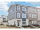 Modern townhome showcasing mixed siding, white brick, multiple windows, and a welcoming entrance at 434 Herring Dr, Acworth, GA 30102