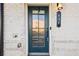 Close-up of a stylish front door with glass panels and modern house number on white brick exterior at 434 Herring Dr, Acworth, GA 30102