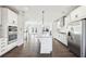 Open kitchen with stainless appliances, island with seating, and hardwood floors at 434 Herring Dr, Acworth, GA 30102