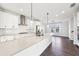 Bright kitchen features a large island, stainless steel appliances, and subway tile backsplash at 434 Herring Dr, Acworth, GA 30102