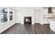 Bright living room with a fireplace, hardwood floors, and large windows showcasing a modern kitchen at 434 Herring Dr, Acworth, GA 30102