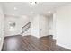 Living room features hardwood floors, staircase with iron spindles and a large window at 434 Herring Dr, Acworth, GA 30102