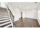 Living room features hardwood floors, staircase with iron spindles and a large window at 434 Herring Dr, Acworth, GA 30102