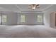 Spacious bedroom with ample natural light from three large windows at 157 Haverling Pass, Hampton, GA 30228