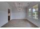 Bright, airy dining room boasts coffered ceiling, chair railing, and many windows at 157 Haverling Pass, Hampton, GA 30228