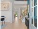 Bright entryway featuring light hardwood floors and elegant wainscoting at 157 Haverling Pass, Hampton, GA 30228