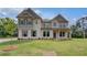 Attractive two-story house boasts detailed trim and shuttered windows at 157 Haverling Pass, Hampton, GA 30228