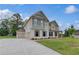 Side view of a stylish home with an attached garage and well-maintained lawn at 157 Haverling Pass, Hampton, GA 30228