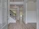 Bright entryway features hardwood floors, elegant wainscoting, and a staircase at 157 Haverling Pass, Hampton, GA 30228