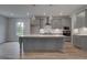 Stylish gray kitchen with stainless steel appliances and a center island with light wood floors at 157 Haverling Pass, Hampton, GA 30228