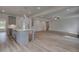 Open floor plan with a kitchen island overlooking the living room and staircase at 157 Haverling Pass, Hampton, GA 30228