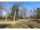 Spacious backyard with mature trees and grassy area at 318 Stewart Nw Ave, Marietta, GA 30064