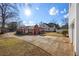 Large backyard with a driveway and mature trees at 318 Stewart Nw Ave, Marietta, GA 30064