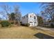 Grassy backyard featuring a two-car garage with an apartment above and mature trees at 318 Stewart Nw Ave, Marietta, GA 30064