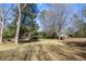 Spacious backyard with lush green grass and mature trees at 318 Stewart Nw Ave, Marietta, GA 30064