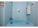 Blue tiled bathroom with shower and a built-in towel rack at 318 Stewart Nw Ave, Marietta, GA 30064