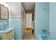 Blue tiled bathroom with bathtub and a separate shower at 318 Stewart Nw Ave, Marietta, GA 30064