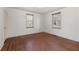 Cozy bedroom featuring beautiful hardwood floors, white walls, and windows at 318 Stewart Nw Ave, Marietta, GA 30064