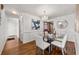 Cozy dining room featuring hardwood floors, a glass table, and a stylish chandelier at 318 Stewart Nw Ave, Marietta, GA 30064